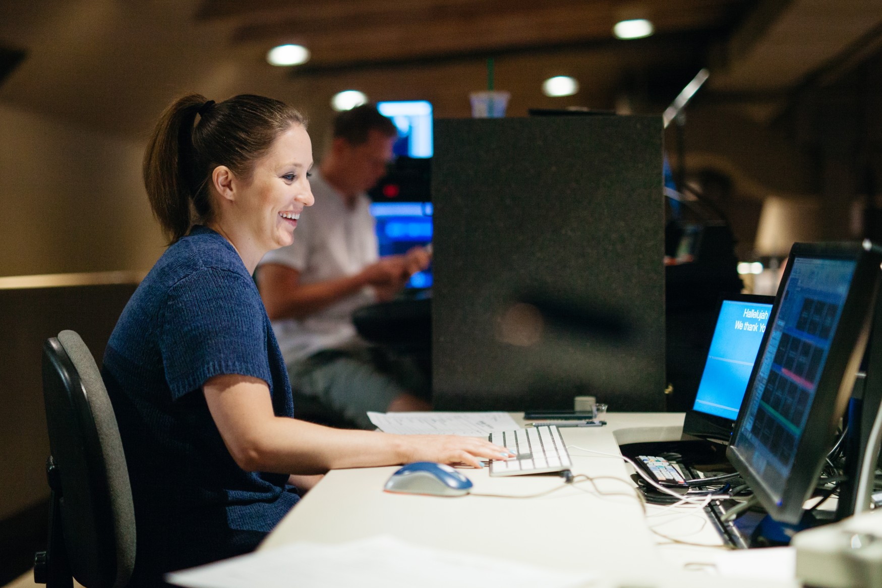 a-woman-works-on-a-computer-while-smiling_t20_loPndo